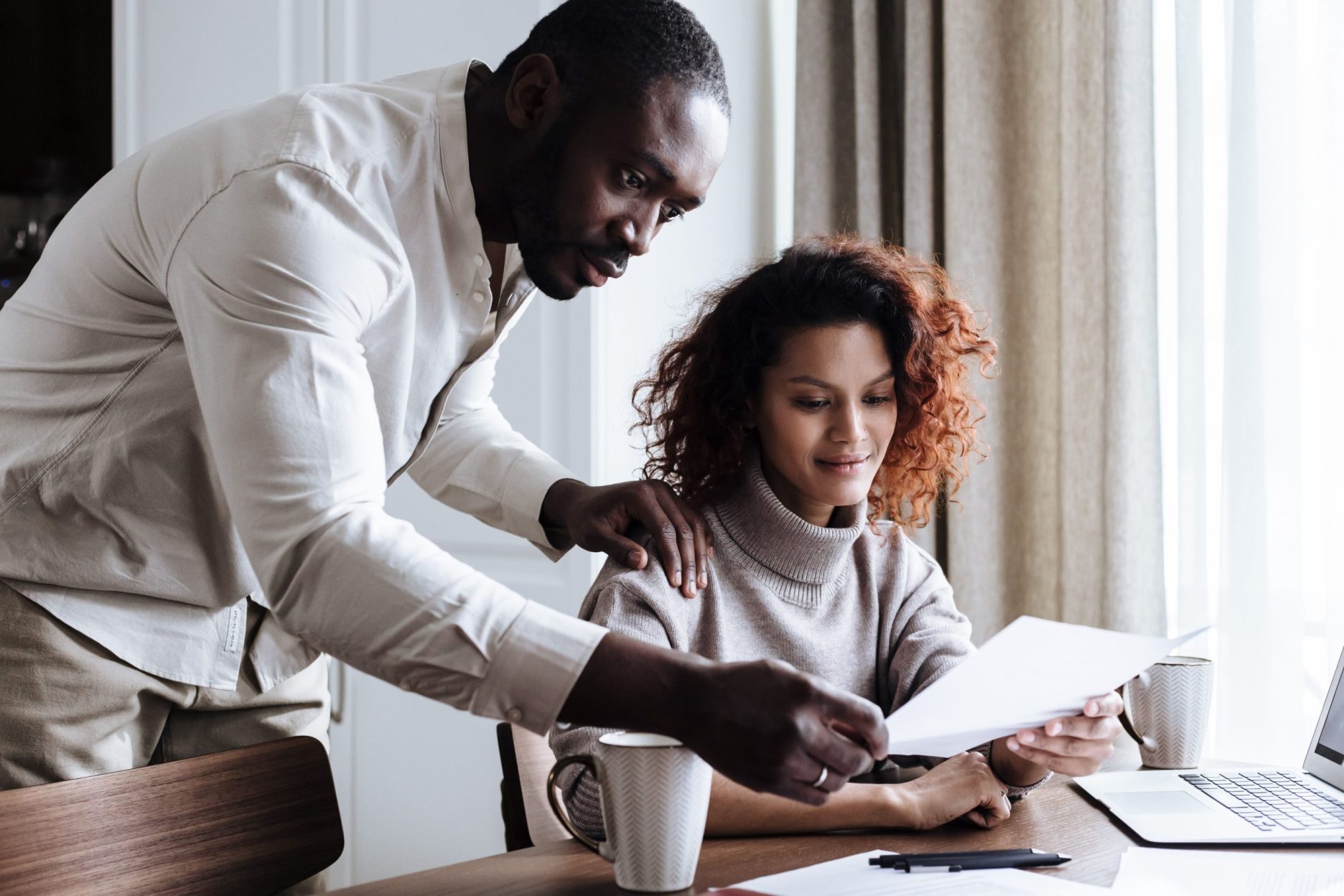 Couple reviewing refinancing documents